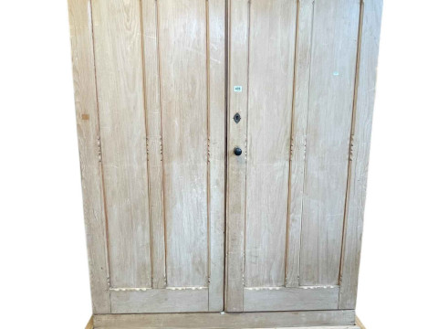 Victorian pine wardrobe having two doors enclosing five sliding trays...