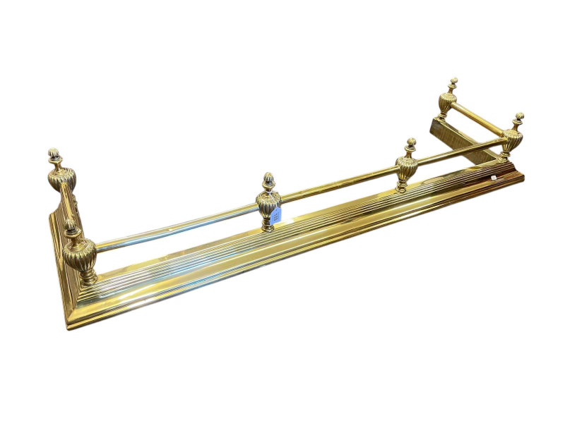 Ornate polished brass fender.