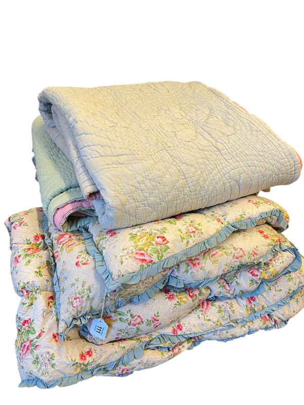 Two Durham quilts and three Eiderdowns.