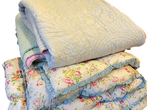 Two Durham quilts and three Eiderdowns.