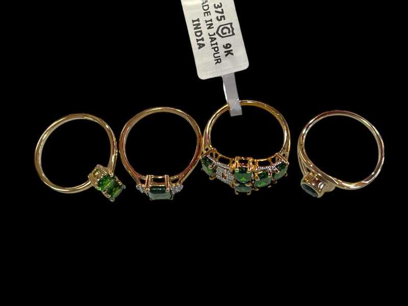 Four 9 carat gold and green diopside rings, two with diamonds.
