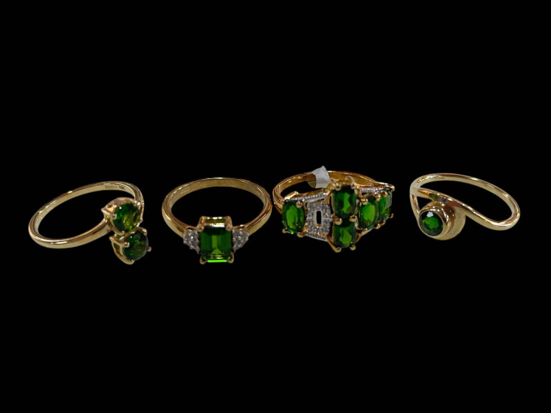 Four 9 carat gold and green diopside rings, two with diamonds.