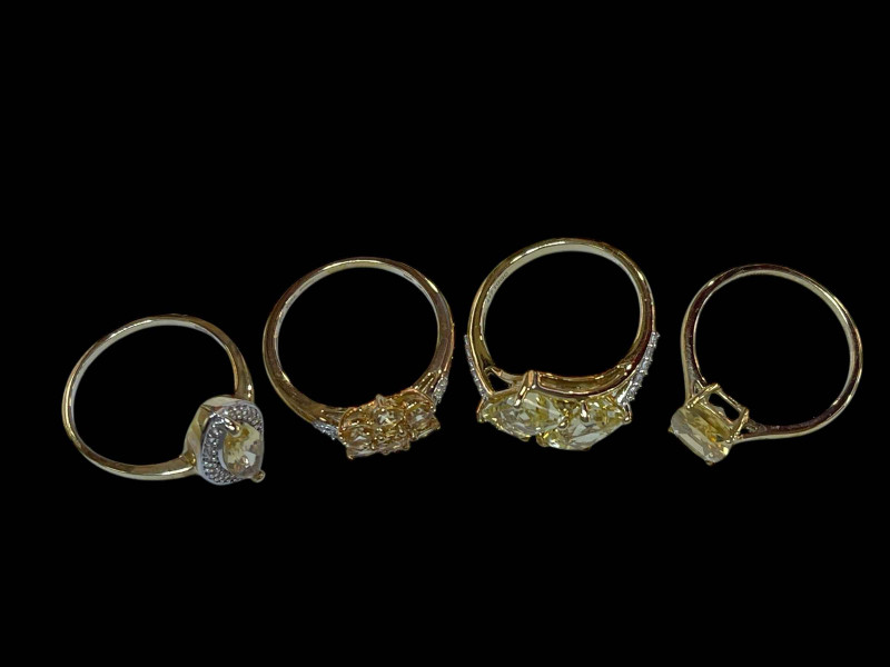 Four 9 carat gold and gem set rings.