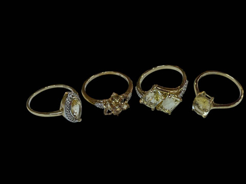 Four 9 carat gold and gem set rings.