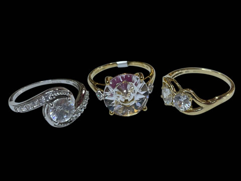Three 9 carat gold and clear stone dress rings.