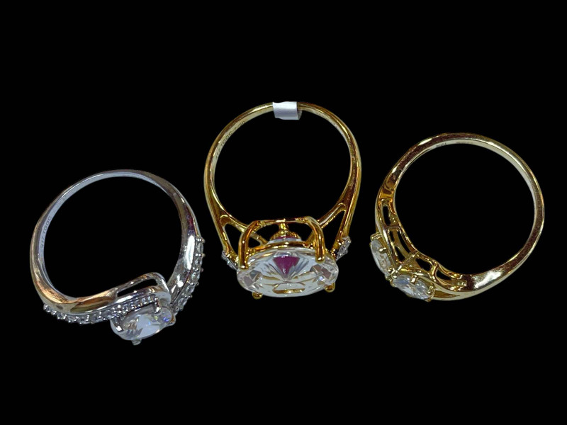 Three 9 carat gold and clear stone dress rings.