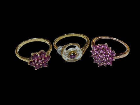 Three 9 carat gold and pink gemstone rings.