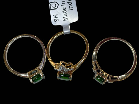 Three 9 carat gold and green gemstone rings. thumbnail