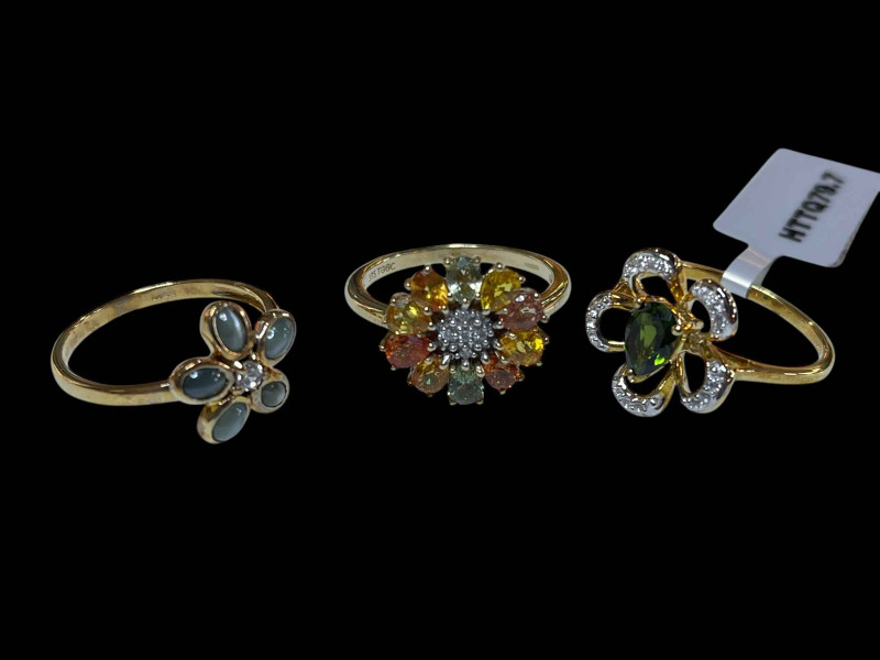 Three 9 carat gold and gem set dress rings.