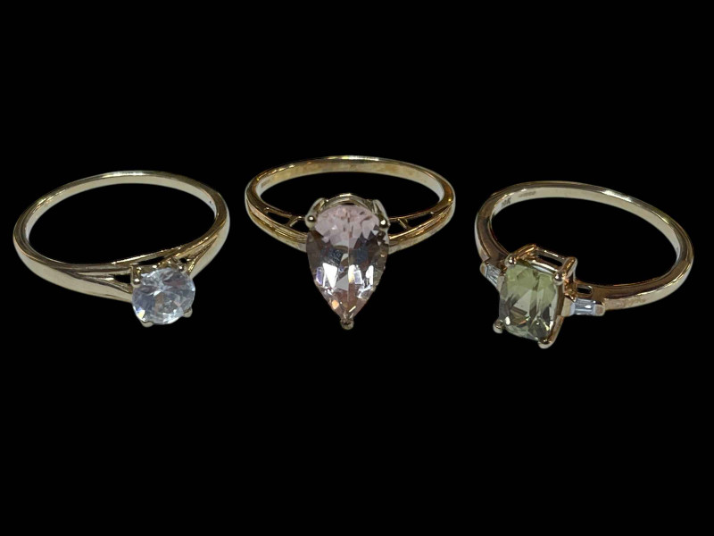 Three 9 carat gold and gem set rings.