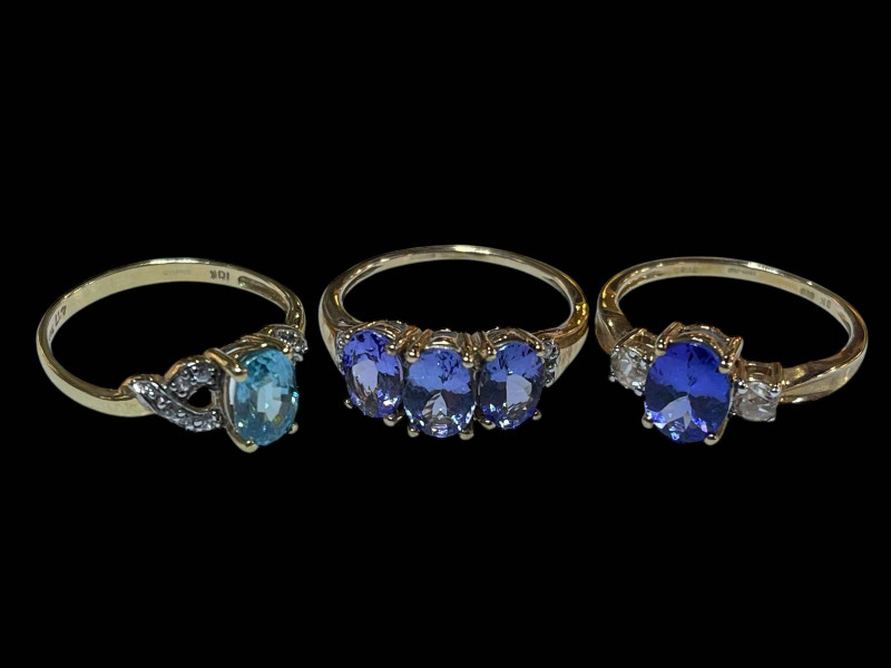 Two Tanzanite and diamond 9 carat gold rings and topaz and diamond ring.