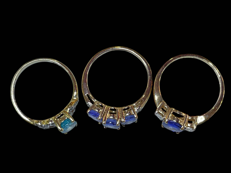Two Tanzanite and diamond 9 carat gold rings and topaz and diamond ring.