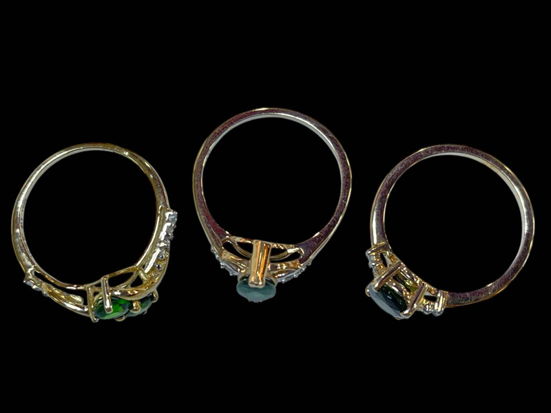 Three 9 carat gold, green gem set and diamond rings.