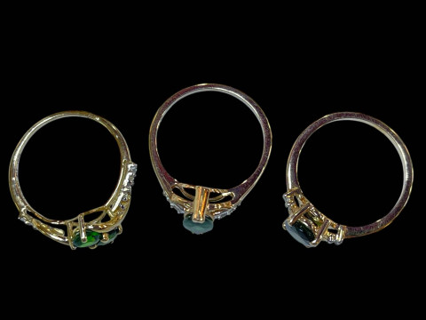 Three 9 carat gold, green gem set and diamond rings. thumbnail