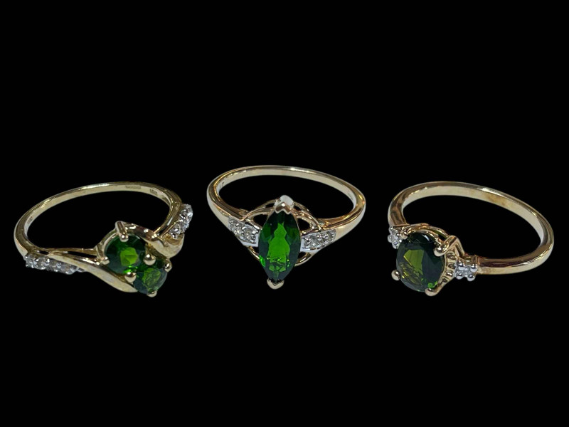 Three 9 carat gold, green gem set and diamond rings.