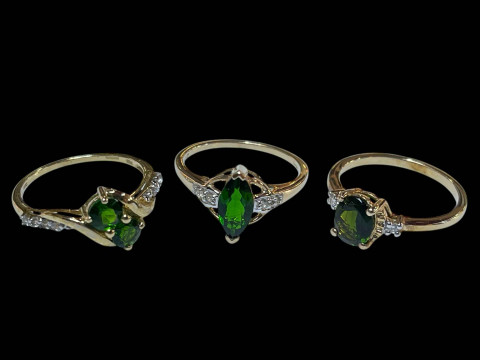 Three 9 carat gold, green gem set and diamond rings.