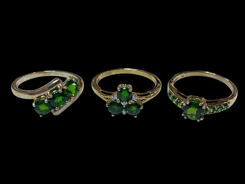 Three 9 carat gold, green gem set and diamond rings.