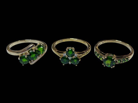 Three 9 carat gold, green gem set and diamond rings.