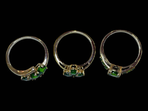 Three 9 carat gold, green gem set and diamond rings. thumbnail