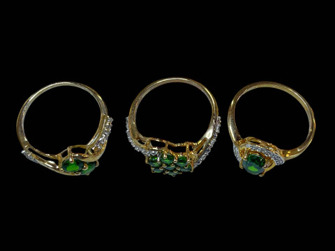 Three 9 carat gold, green gem set and diamond rings. thumbnail