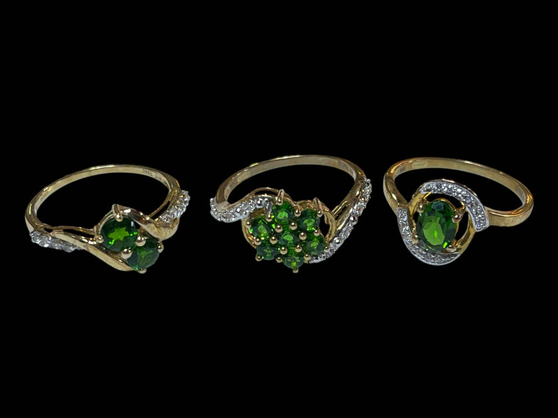 Three 9 carat gold, green gem set and diamond rings.