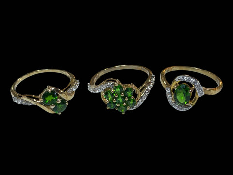 Three 9 carat gold, green gem set and diamond rings.
