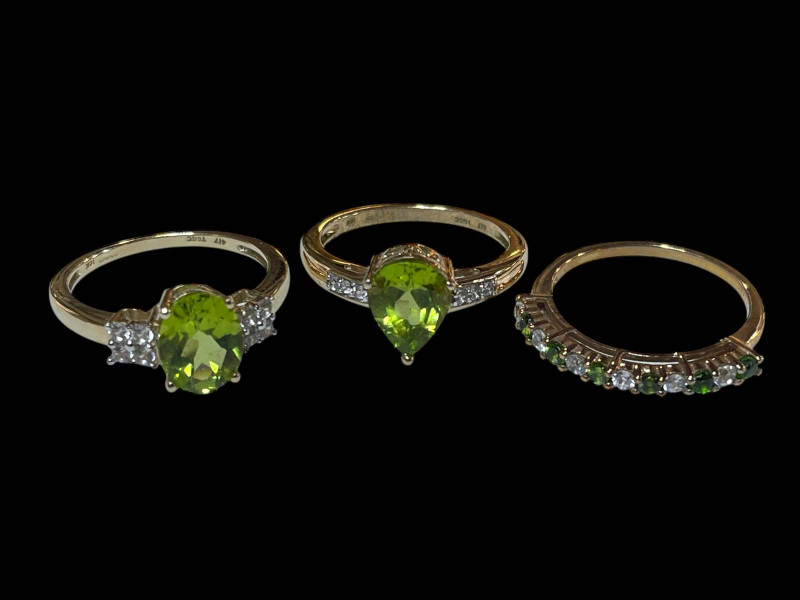 Three 9 carat gold, green gem set and diamond rings.