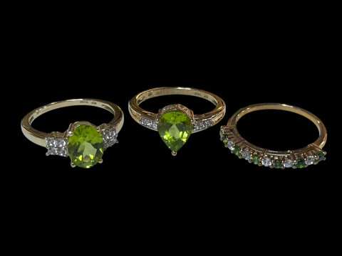 Three 9 carat gold, green gem set and diamond rings.