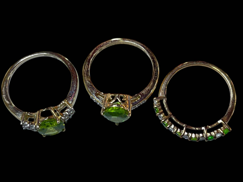 Three 9 carat gold, green gem set and diamond rings.