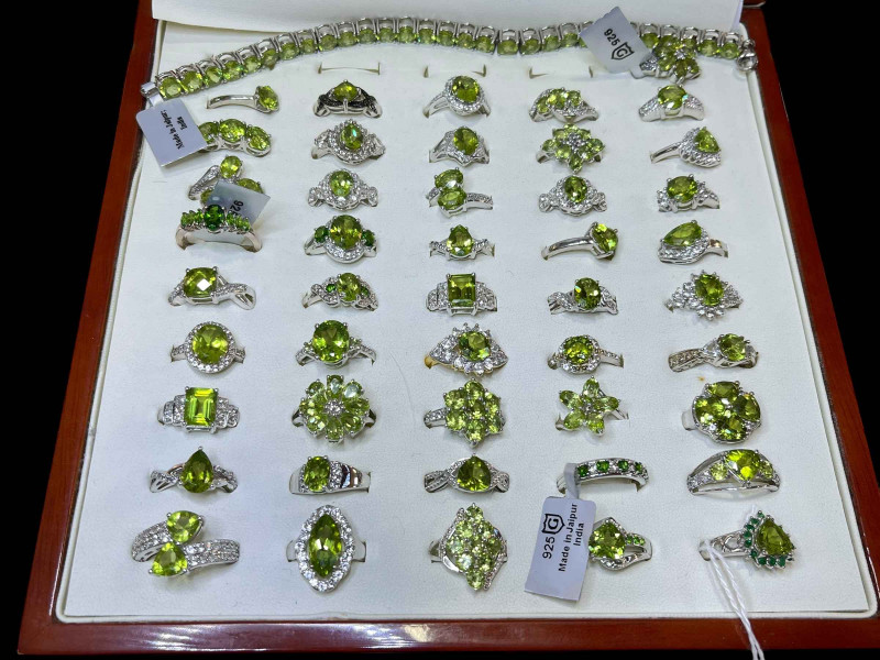Cased collection of silver and green gem set dress rings (46), and a bracelet.