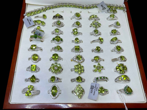 Cased collection of silver and green gem set dress rings (46), and a bracelet.