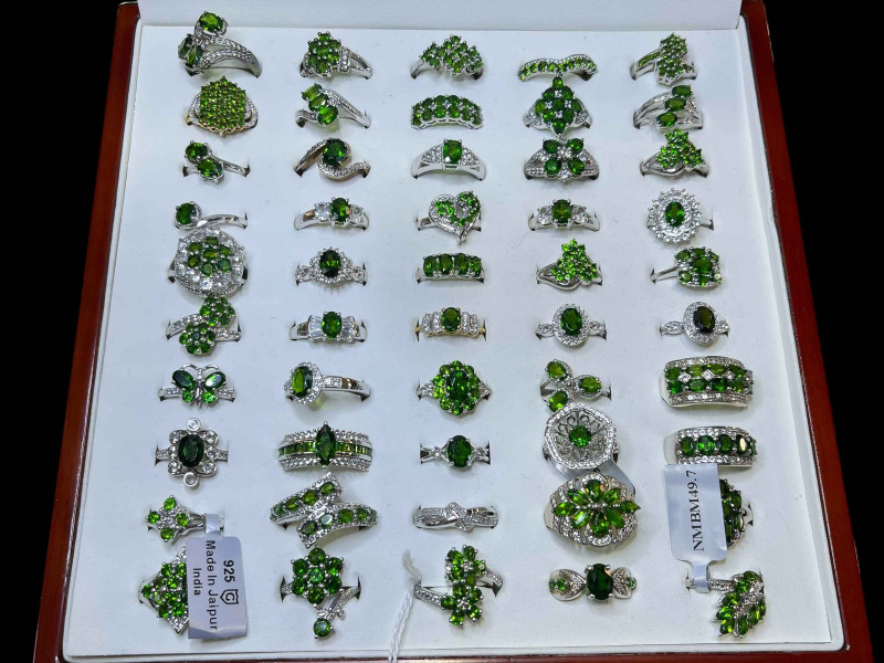 Cased collection of silver and green gem set dress rings (50).