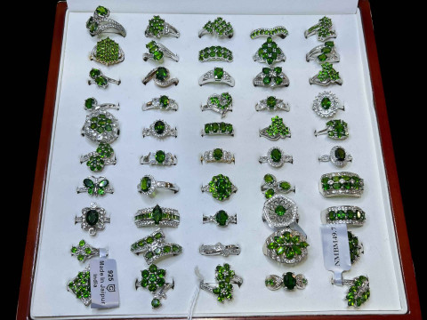 Cased collection of silver and green gem set dress rings (50).