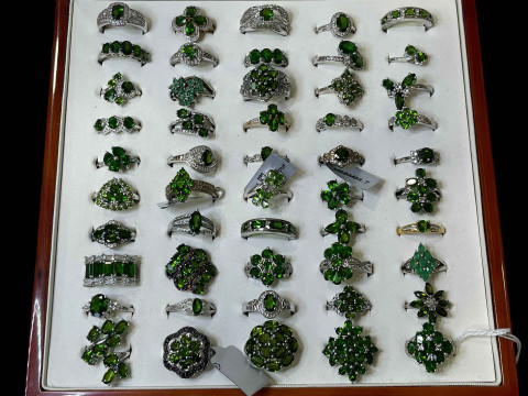 Cased collection of silver and green gem set dress rings (50).