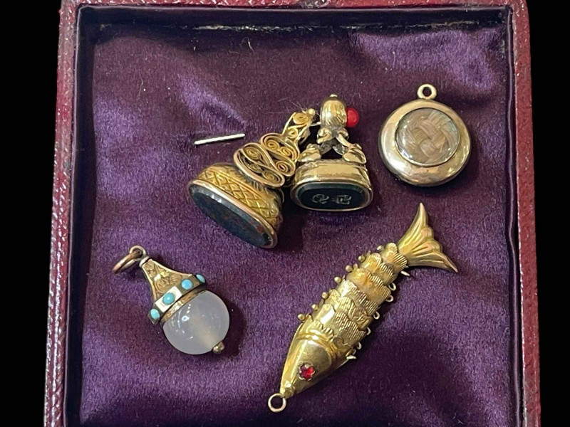 Two hardstone fobs, 14k reticulated fish pendant with ruby set eyes, mourning pendant and another.