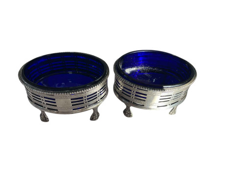 Pair of silver salts raised on claw feet with Bristol blue glass liners.