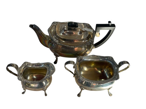 Edwardian three piece silver tea set on paw feet with gadroon border.