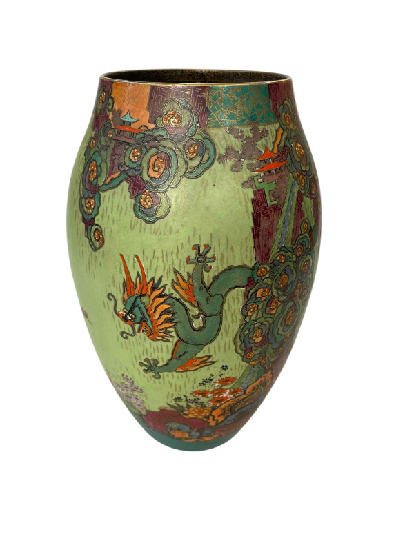 Crown Devon vase decorated with mythical dragons in floral landscape.