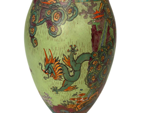 Crown Devon vase decorated with mythical dragons in floral landscape.