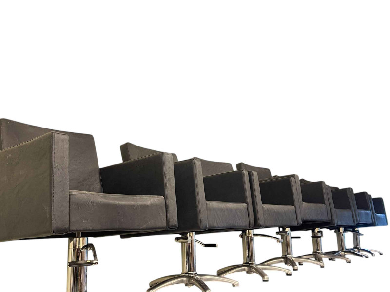 Set of seven Lotus hydraulic swivel salon chairs.