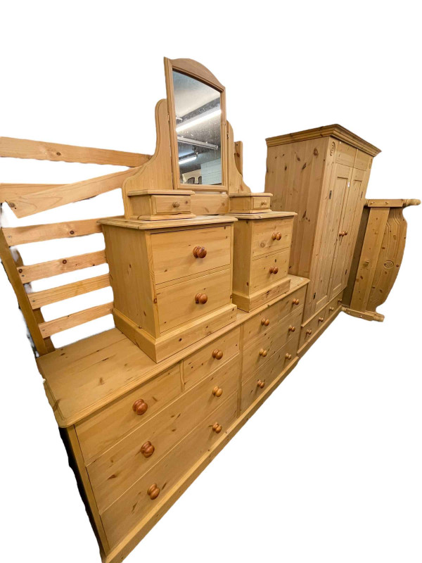 Six piece pine bedroom suite comprising two door wardrobe with two base drawers, 199cm by 146cm by 56cm, chest of four short above four long drawers, 89cm by 185cm by 43.5cm, pair two drawer pedestals, dressing mirror and double bedstead.