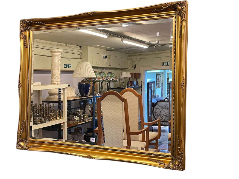 Oval twin pedestal extending dining table with integral leaf, set of six chairs including pair carvers and gilt framed bevelled wall mirror.