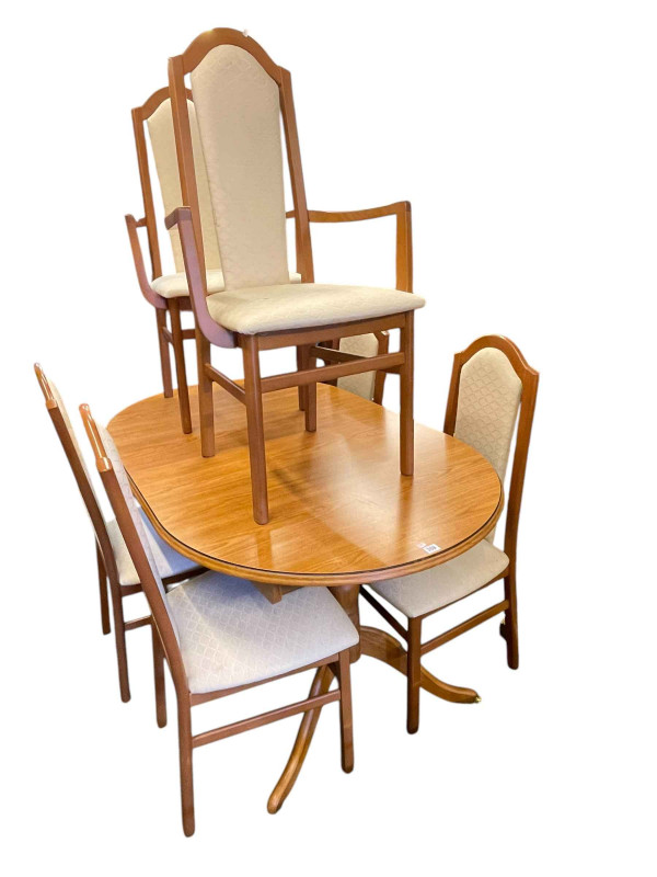 Oval twin pedestal extending dining table with integral leaf, set of six chairs including pair carvers and gilt framed bevelled wall mirror.