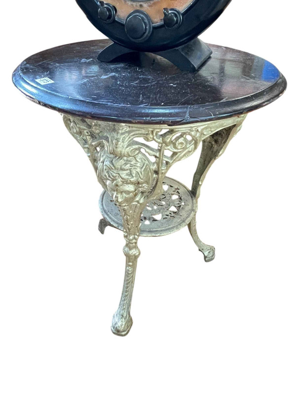 Circular cast base pub table, 70cm by 56cm diameter.
