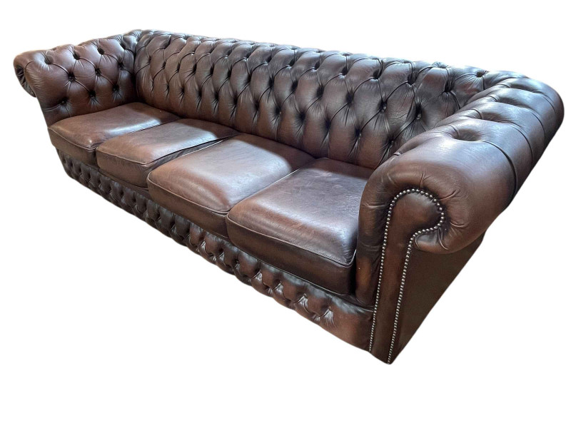 Brown buttoned leather and studded four seater Chesterfield settee, 72cm by 246cm by 90cm.