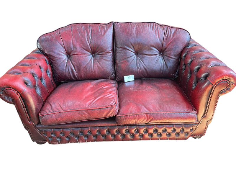 Pair ox blood buttoned leather two seater settees, 94cm by 177cm by 95cm.