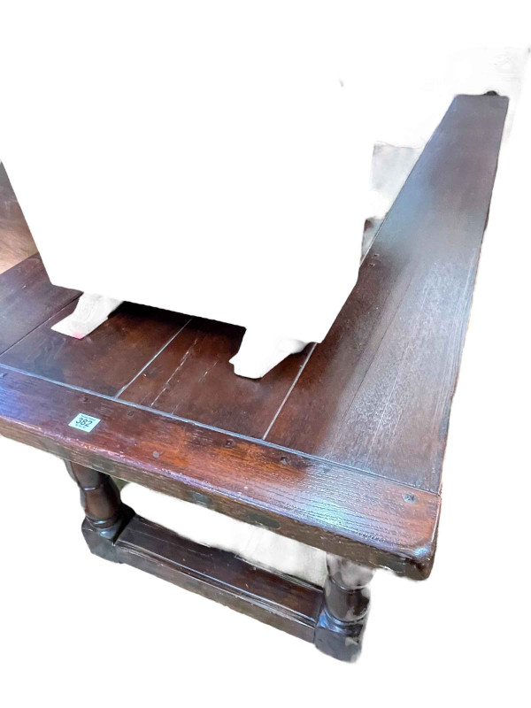 Oak refectory dining table with carved frieze, 78cm by 82cm by 214cm, together with a set of eight studded leather arched high back dining chairs.