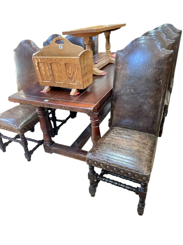 Oak refectory dining table with carved frieze, 78cm by 82cm by 214cm, together with a set of eight studded leather arched high back dining chairs.