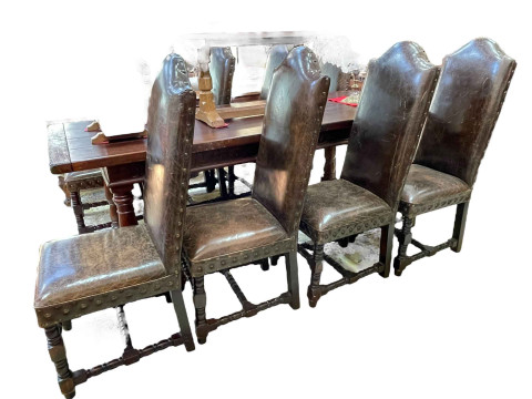 Oak refectory dining table with carved frieze, 78cm by 82cm by 214cm, together with a set of eight studded leather arched high back dining chairs. thumbnail