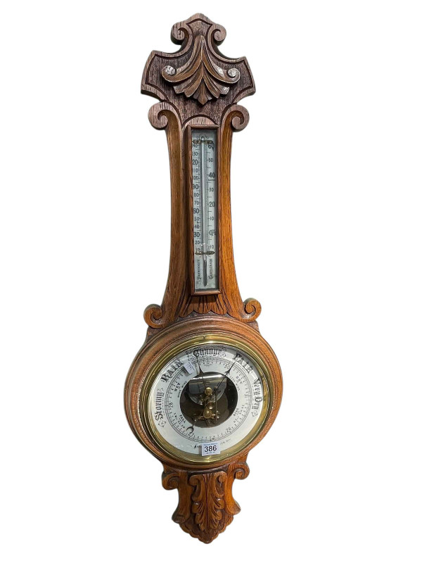 Carved oak aneroid barometer.
